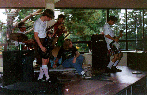 the band playing a show for their high school, but in knee-high socks
