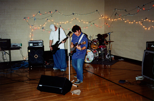 the band playing a show in a gym somewhere