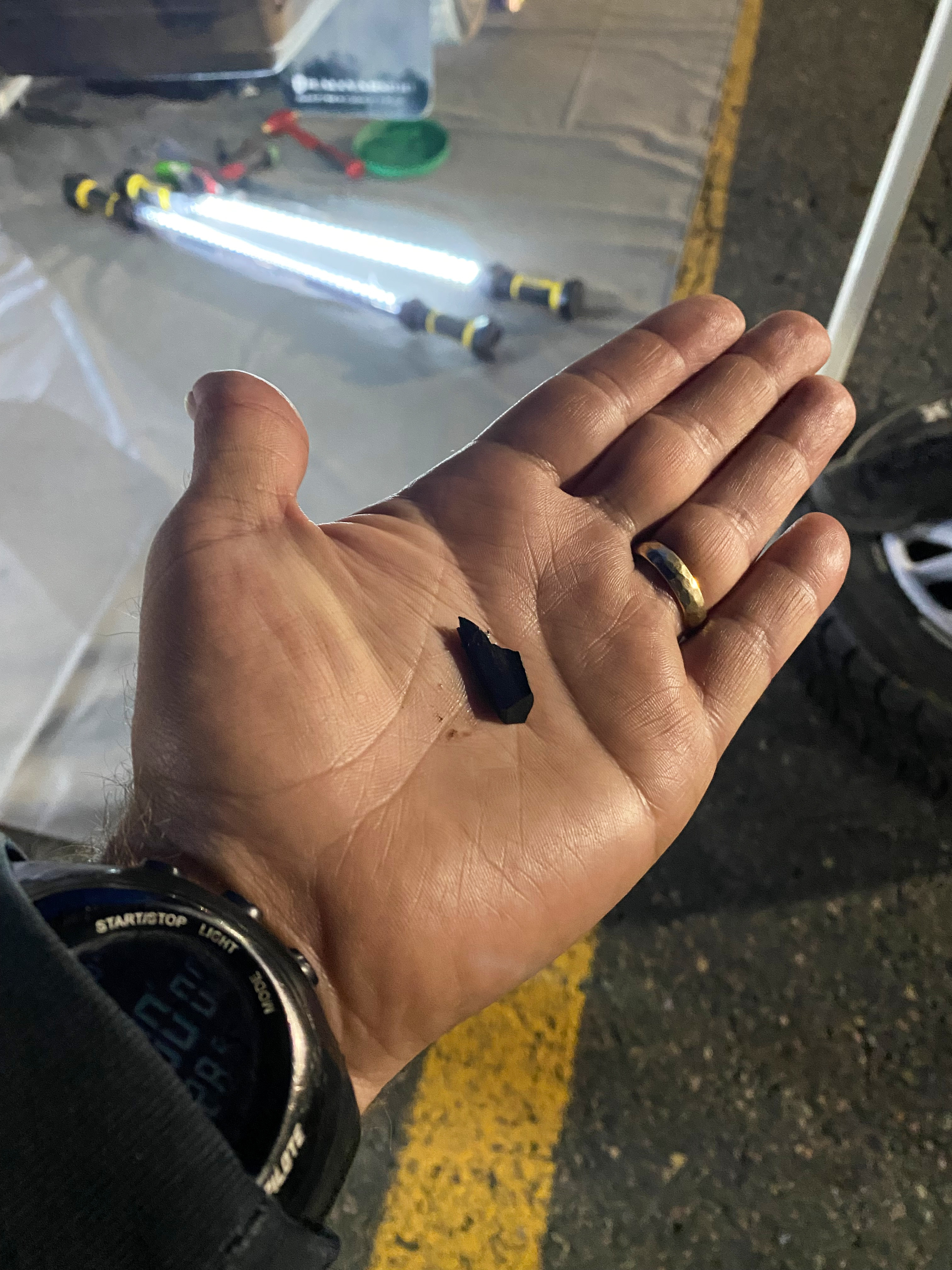 a shard of metal from a rear differential in the hand of a rally co-driver